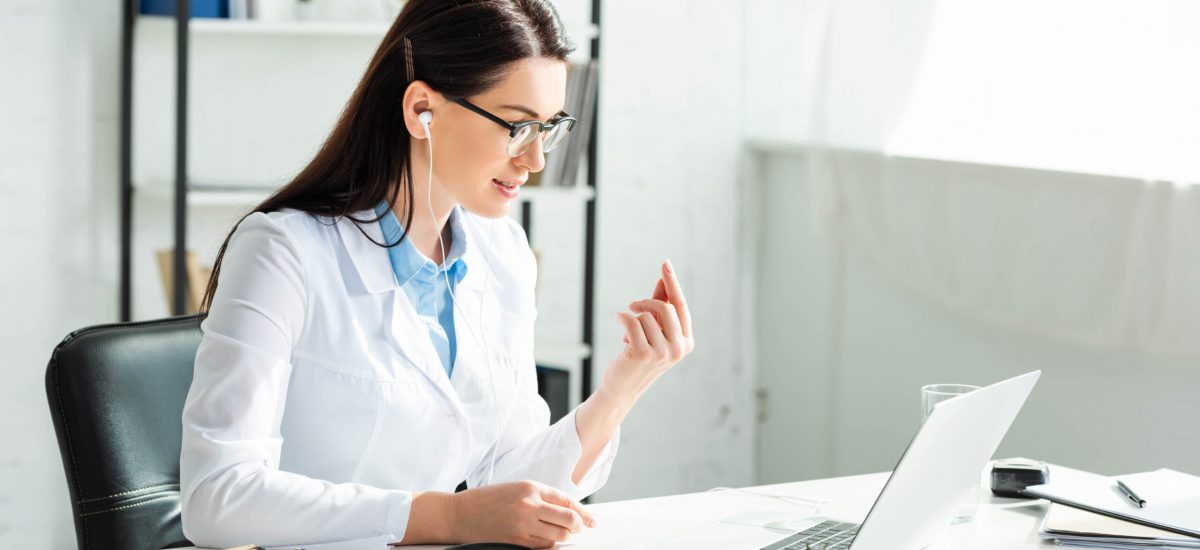 Female,Positive,Doctor,In,Earphones,Having,Online,Consultation,With,Patient